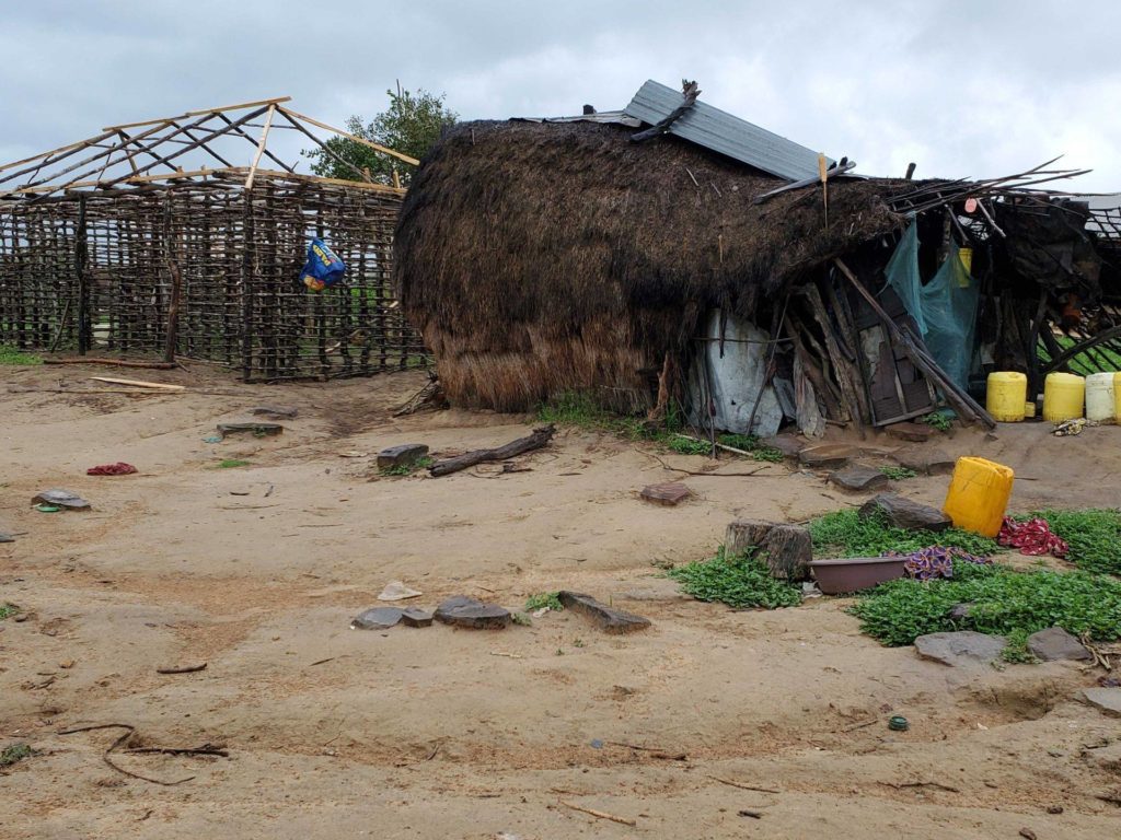 Mariamu and Karisa — GiveDirectly recipients in Kilifi, Kenya — are using their GiveDirectly transfer to build a new home. (Their current house is in the front, and the skeleton for the new one behind it.) The couple has prioritized paying for school fees over home repairs; their eldest child is currently studying at a medical college, and the younger two are in primary and secondary school, respectively. Receiving a cash transfer meant that Mariamu and Karisa could invest in building a new home in addition to continuing payments for their children's schooling.